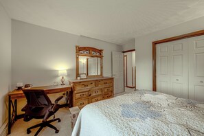 A bedroom with a bed, a dresser, a desk, and a chair. - Charming Lewisburg Home w/ Hot Tub & Games! (Lewisburg)