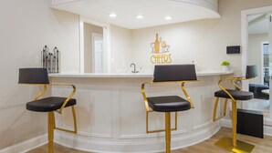 A bar area with three stools, a counter, and a wall-mounted sign. - ★4BR Dallas Family Estate | Heated Pool + Hot Tub | Sleeps 16 | Lake Highlands★ (Dallas)