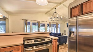 A modern kitchen with a stainless steel refrigerator, a built-in oven, and a wooden countertop. - Eatonton Getaway on Lake Sinclair w/ Dock! (Eatonton)