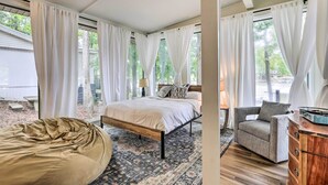 A bedroom with a bed, a bean bag, a chair, and a dresser. - Eatonton Getaway on Lake Sinclair w/ Dock! (Eatonton)