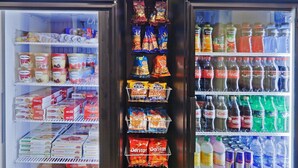 A vending machine with snacks and drinks. - 1 Bedroom | Free Breakfast, Pool Access (Oklahoma City)
