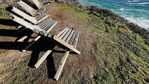 A coastal view with wooden benches overlooking the ocean. - Timber Cove Resort (Jenner)