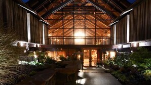 A large, rustic building with a prominent wooden facade and a high, triangular roof structure. - Timber Cove Resort (Jenner)