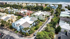 A coastal residential area with houses, a parking lot, and a view of the ocean. - Quail Hollow A8-1U:  Beach Condo with Pool Access - Family Friendly (St. Augustine)
