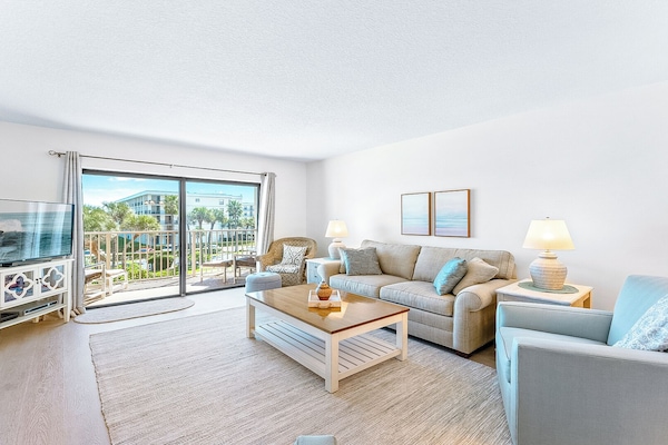 Spacious and inviting living room with a cozy coastal touch.