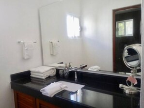 A bathroom with a black countertop, a sink, a mirror, and a window. - Playacar Villa 10 pax ruins & beach (Playa del Carmen)