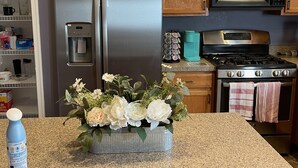 A kitchen with wooden cabinets, a stainless steel refrigerator, a microwave, a stove, and a water dispenser. - Vacation Home in Delmar (Delmar)