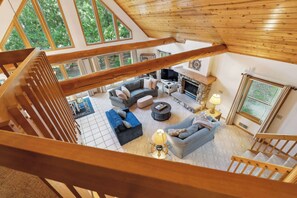 A spacious living area with a fireplace, comfortable seating, and large windows. - Spacious Home in Fish Creek | Peloton + Walk to Shops + Close to State Park (Fish Creek)