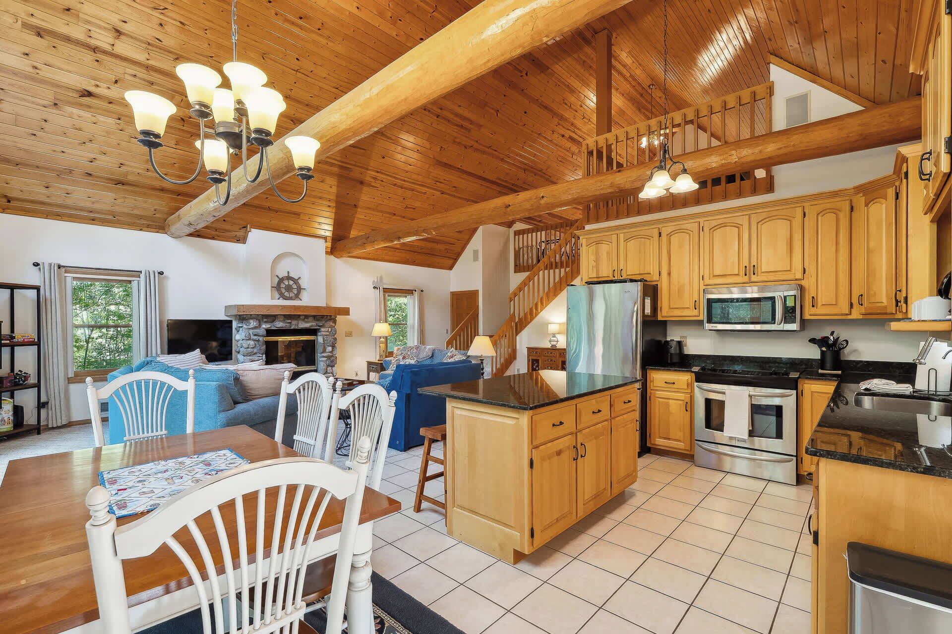 A spacious kitchen with wooden cabinets, a central island, and modern appliances.