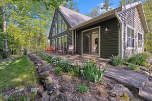A house with a deck, a covered patio, and a stone pathway. - Spacious Home in Fish Creek | Peloton + Walk to Shops + Close to State Park (Fish Creek)