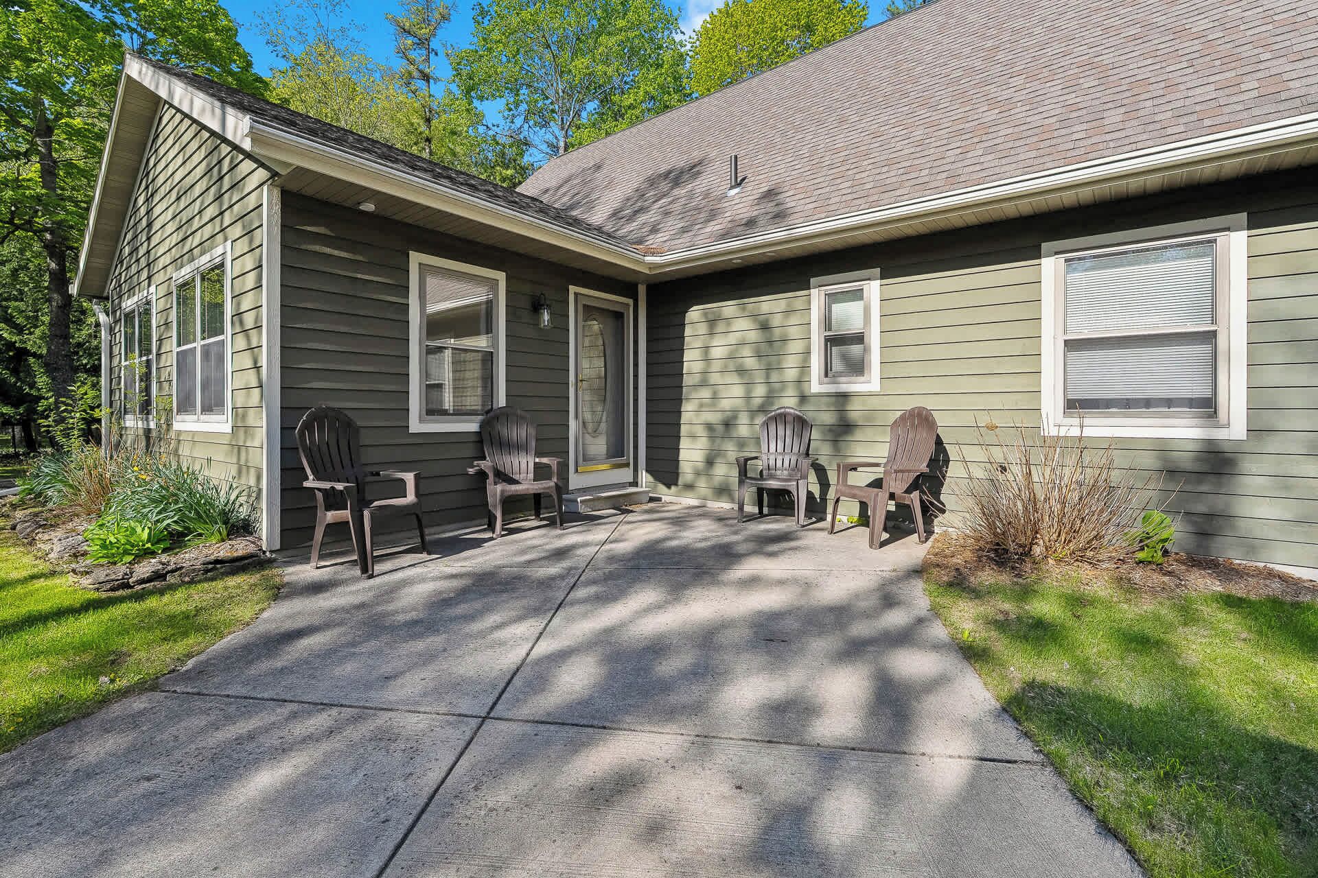 A house with a covered porch, a chimney, and a front door.