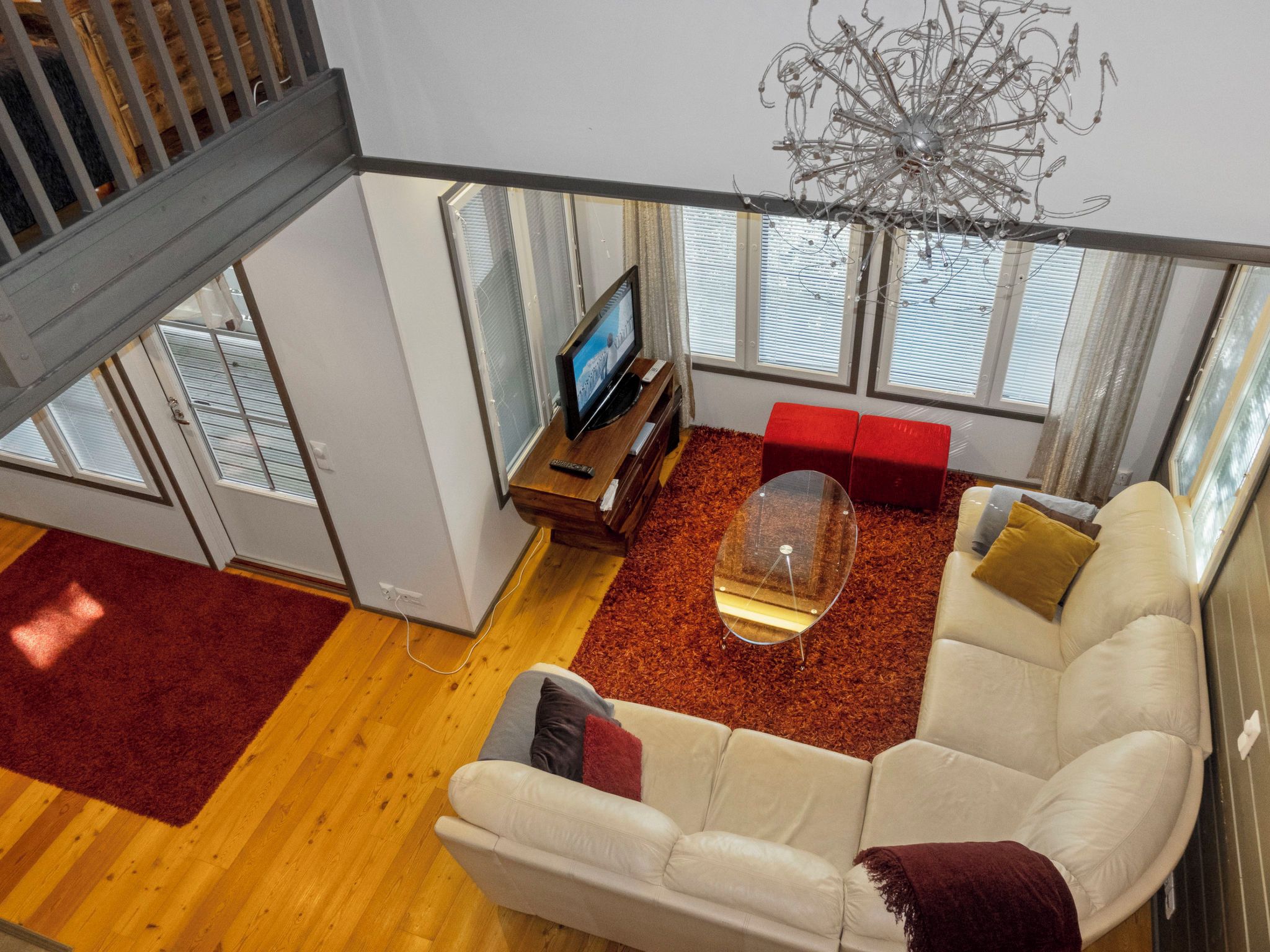 A modern living room with a sofa, a coffee table, and a TV.