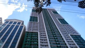 A high-rise building with multiple floors, featuring a mix of glass and concrete facades. - The SCENIC: Comfortable living by Awsom Phil (Manila)