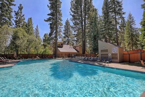A swimming pool with lounge chairs and a building with a clock. - Walk to Lake Tahoe - Pet-Friendly Cabin - Sleeps 7, Kids Welcome (Carnelian Bay)