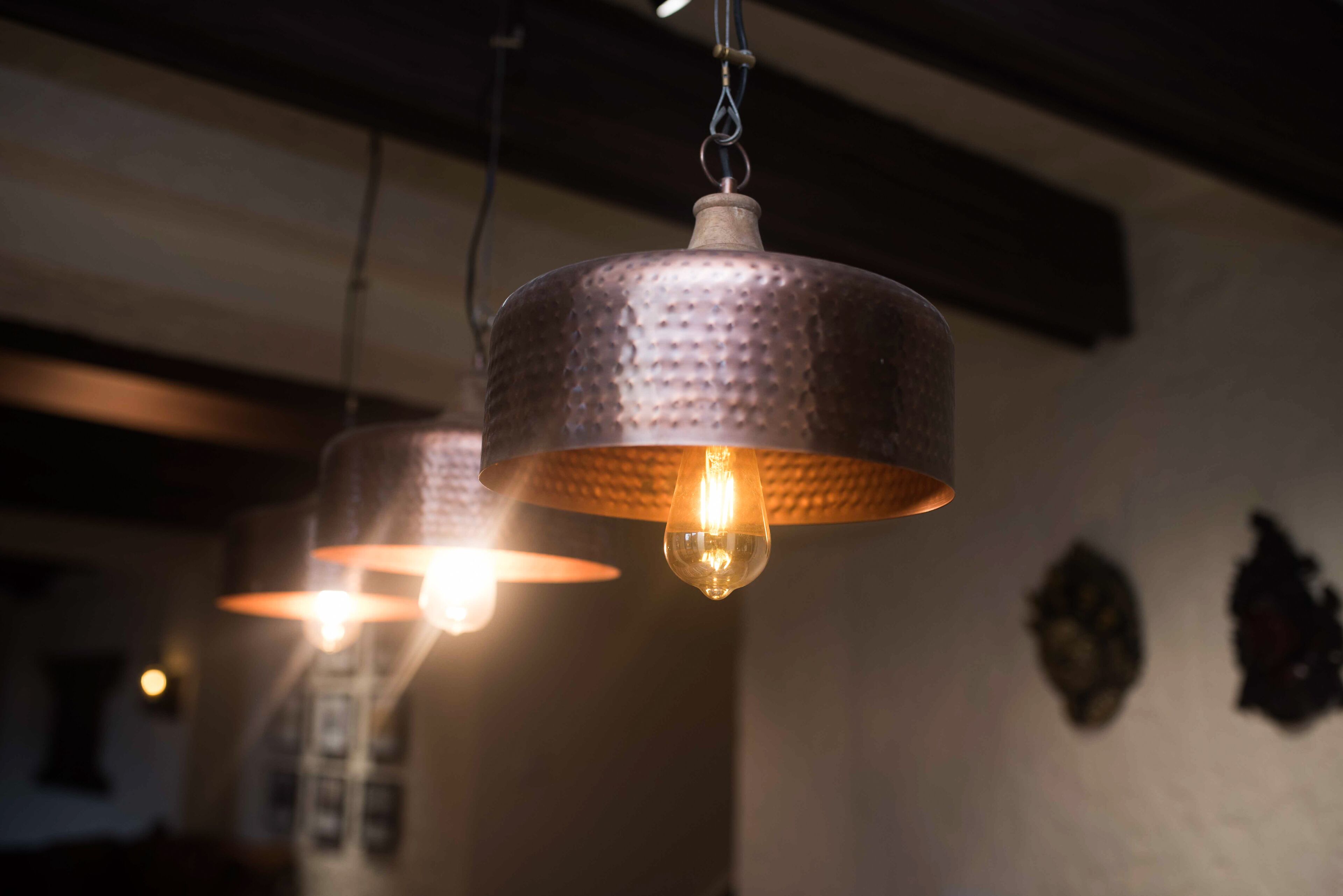 Two hanging pendant lights with a textured surface and visible bulbs.
