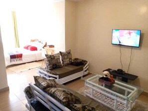 Deluxe Studio | Living area | 14-inch Smart TV with digital channels, TV - Stay.Plus Legacy Studio Apartment (Nairobi)