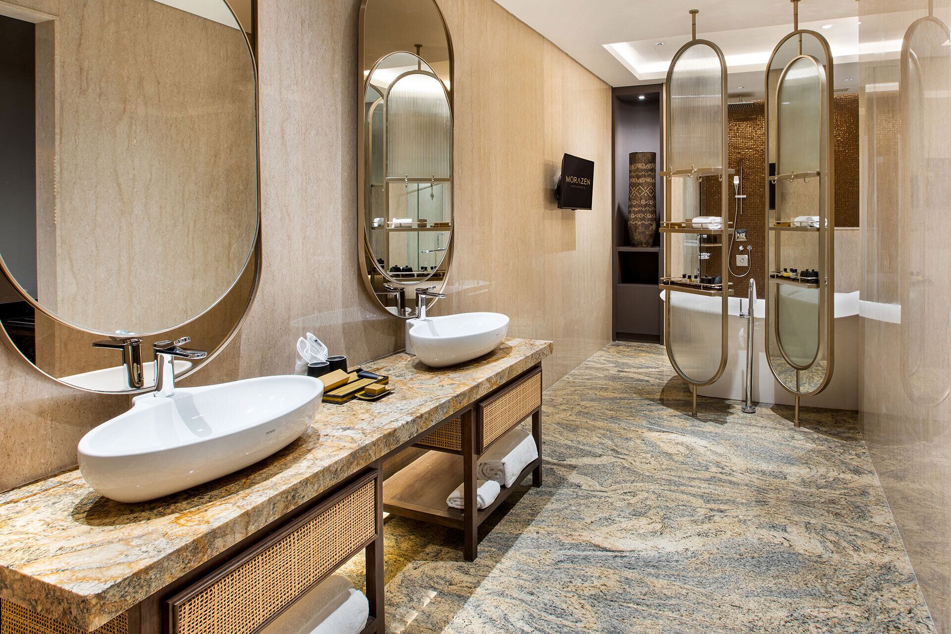 A modern bathroom with two large sinks, a mirror, and a shower enclosure.