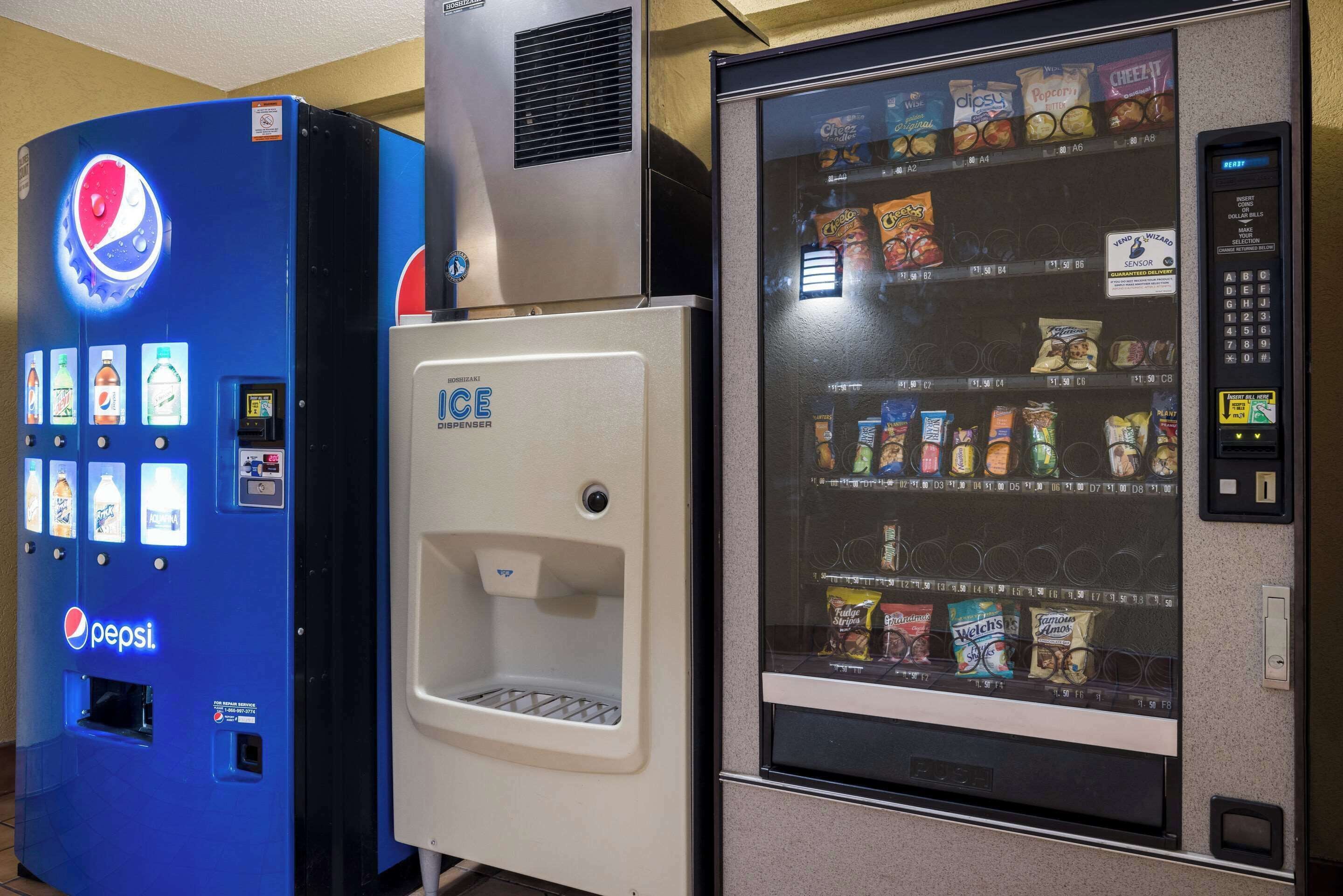 A vending machine with a Pepsi logo and a freezer compartment.