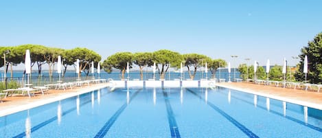 Seasonal outdoor pool, open 10:00 AM to 6:00 PM, pool umbrellas