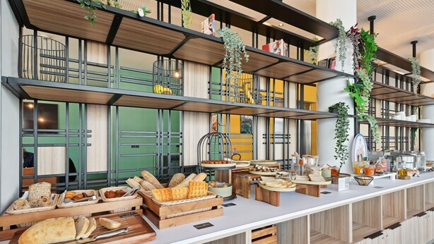 A breakfast buffet with various breads, pastries, and breakfast items. - All Suites Appart Hôtel | Paris Ouest - Colombes (Colombes)