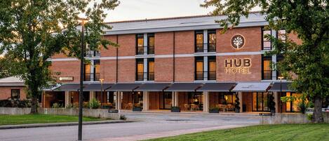 A brick building with a sign reading "Hub Hotel".
