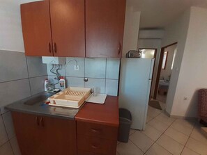 A kitchen with wooden cabinets, a sink, and a countertop.