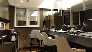 A modern kitchen with a marble countertop, bar stools, and a laptop. - HUB HOTEL XIMEN XINING INN (Taipei)