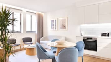 Deluxe Apartment, 2 Bedrooms, Courtyard View | Living area | 28-inch Smart TV with cable channels, TV, MP3 dock