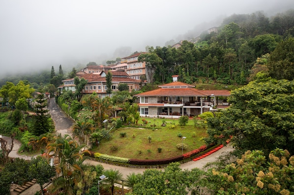 A residential area with houses surrounded by lush greenery and a well-maintained garden.