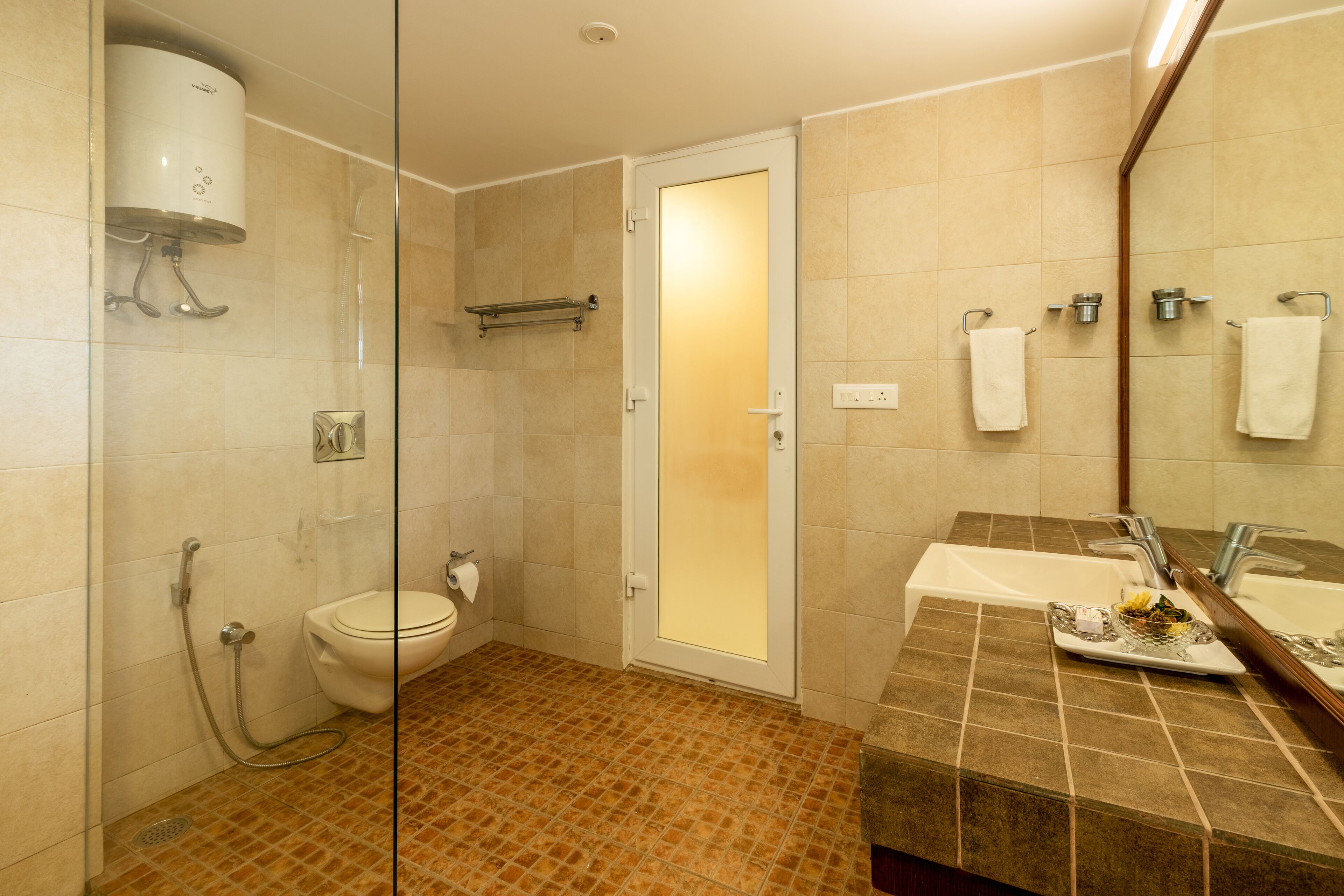 A bathroom with a shower, toilet, and sink.