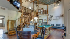 A spacious living area with a pool table, a wooden staircase, and a cozy seating area. - Lakefront Estate With 2 Kitchens Perfect for Events & Families (Nevada)