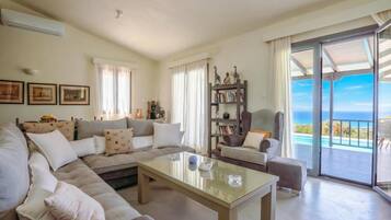 Family House, Multiple Bedrooms (Villa Filokalia With Exceptional View) | Living area | 21-inch TV with cable channels, fireplace