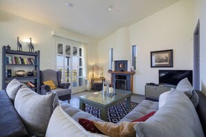 Family House, 3 Bedrooms (Villa Filokalia With Exceptional View) | Living room | 21-inch TV with cable channels, fireplace