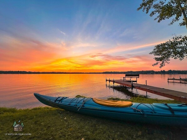 A kayak on a dock with a sunset view. - Edgewater Retreat on Beautiful Soo Lake! (Phillips)