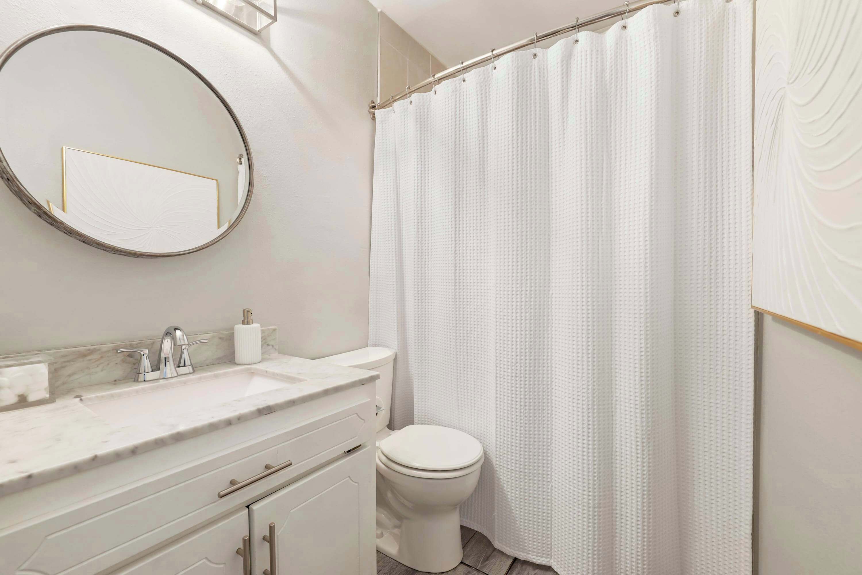 Bathtub, hair dryer, towels, shampoo