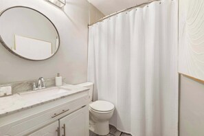 Bathtub, hair dryer, towels, shampoo