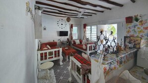 A cozy room with a bunk bed, a small table, and a window with red curtains. - Stay.Plus Nyumba Tulivu Watamu (Watamu)