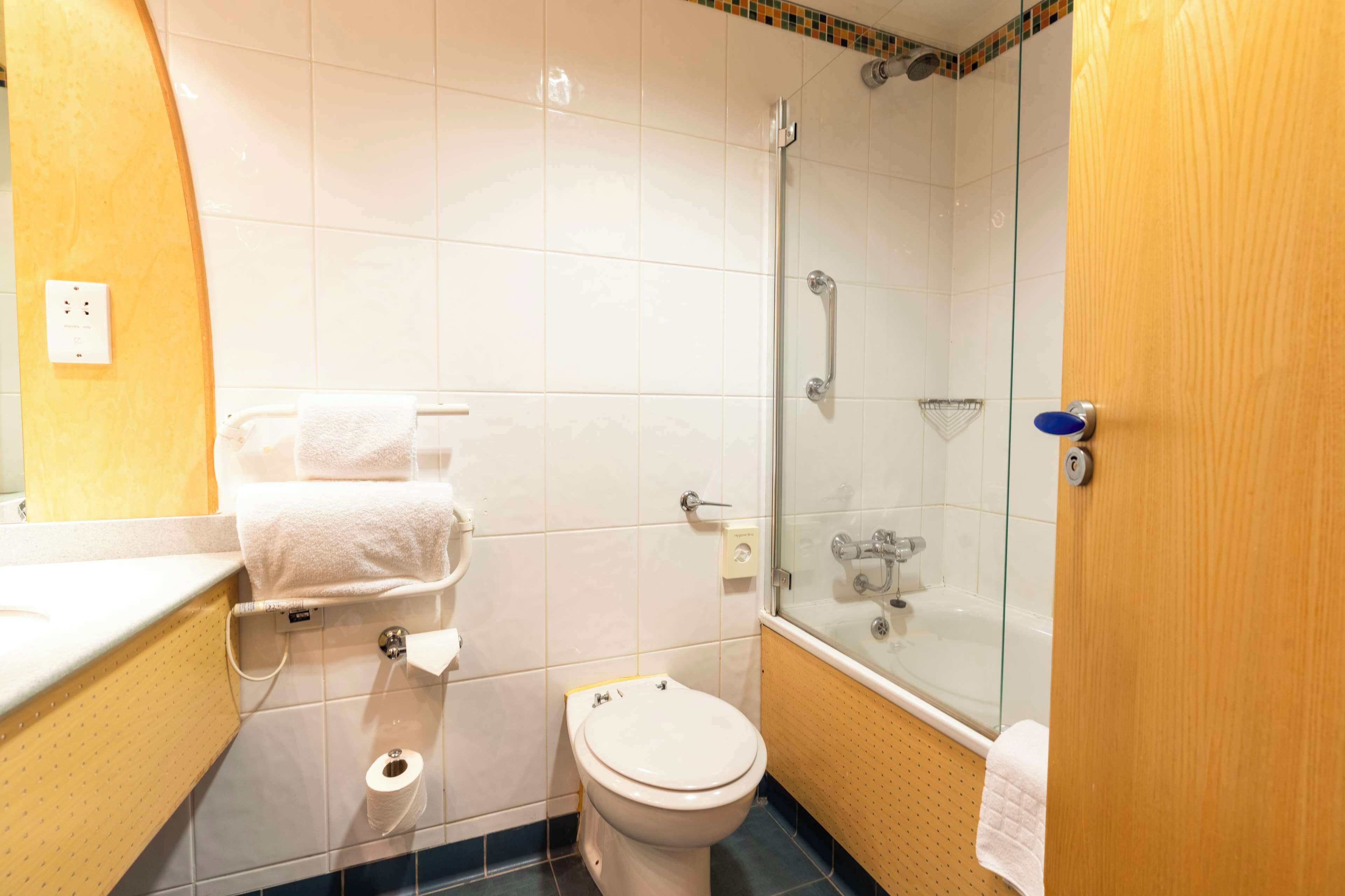 A bathroom with a toilet, sink, and shower.