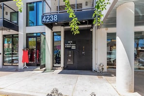 A modern building with a storefront labeled "4238" and "LUX Craftsman Court UNITS 2001 2002".