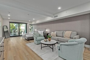 Relax in this stylish living room with a large sofa, armchairs, and a coffee table.