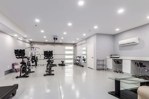 Stay fit and active in our well-equipped gym featuring treadmills, weightlifting stations, and a computer for planning your workout.