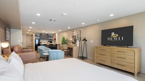 A hotel room with a large bed, a TV, a desk, and a kitchenette. - NEW|Luxe Cypress Suite @ Cedara |Heart of Old Town (Scottsdale)