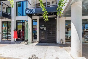 A modern building with a storefront labeled "4238" and "LUX Craftsman Court UNITS 2001 2002".