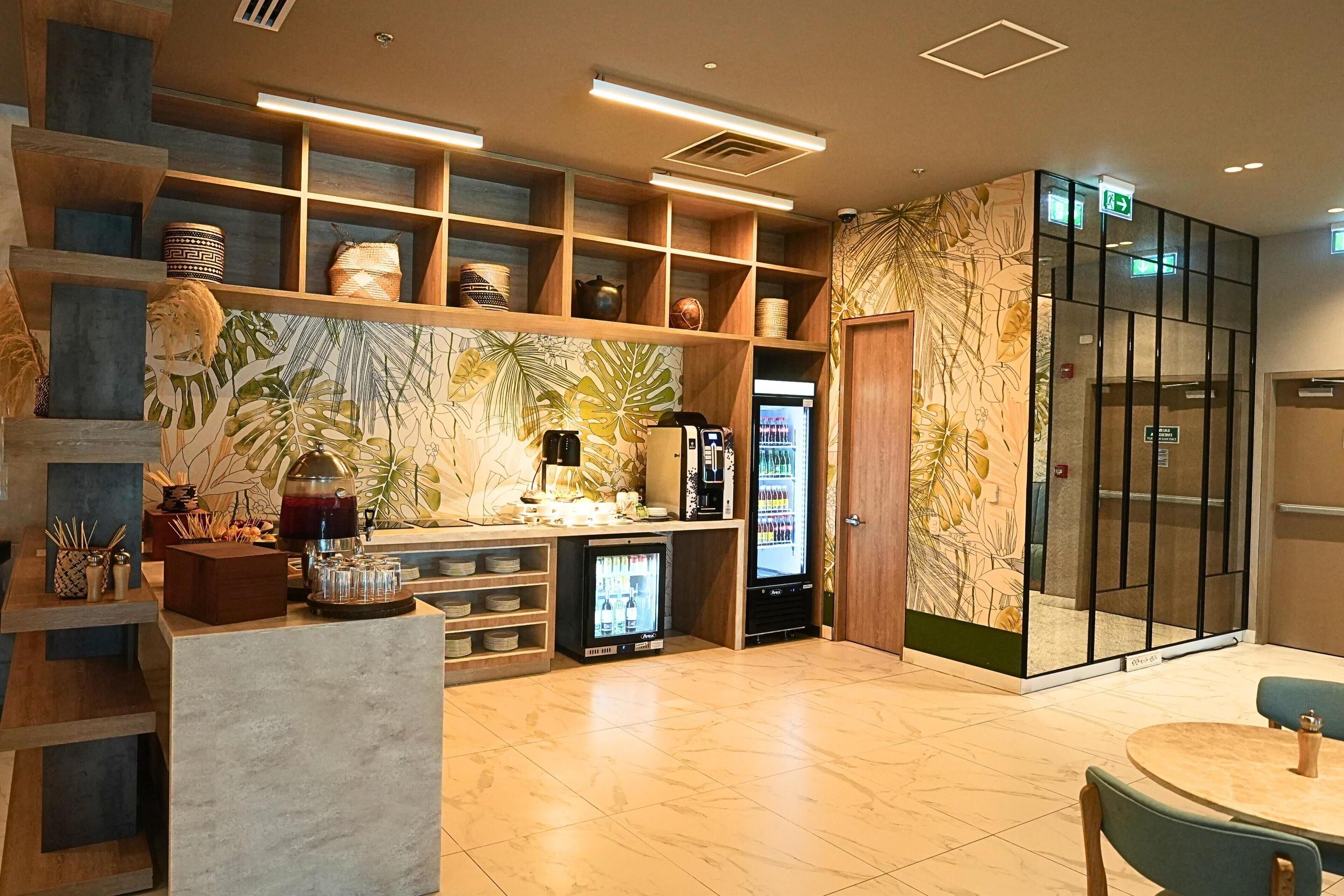 A modern interior with wooden shelves, a coffee machine, and a refrigerator.