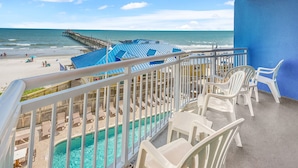 A balcony with a pool, beach view, and a pier. - 1st Rate Views & Amenities - Ritzy Oceanfront Family Resort w/pools, pier restaurant/bar in Ocean Dr (North Myrtle Beach)