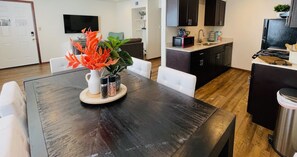 Una cocina moderna con armarios oscuros, un microondas y un fregadero.