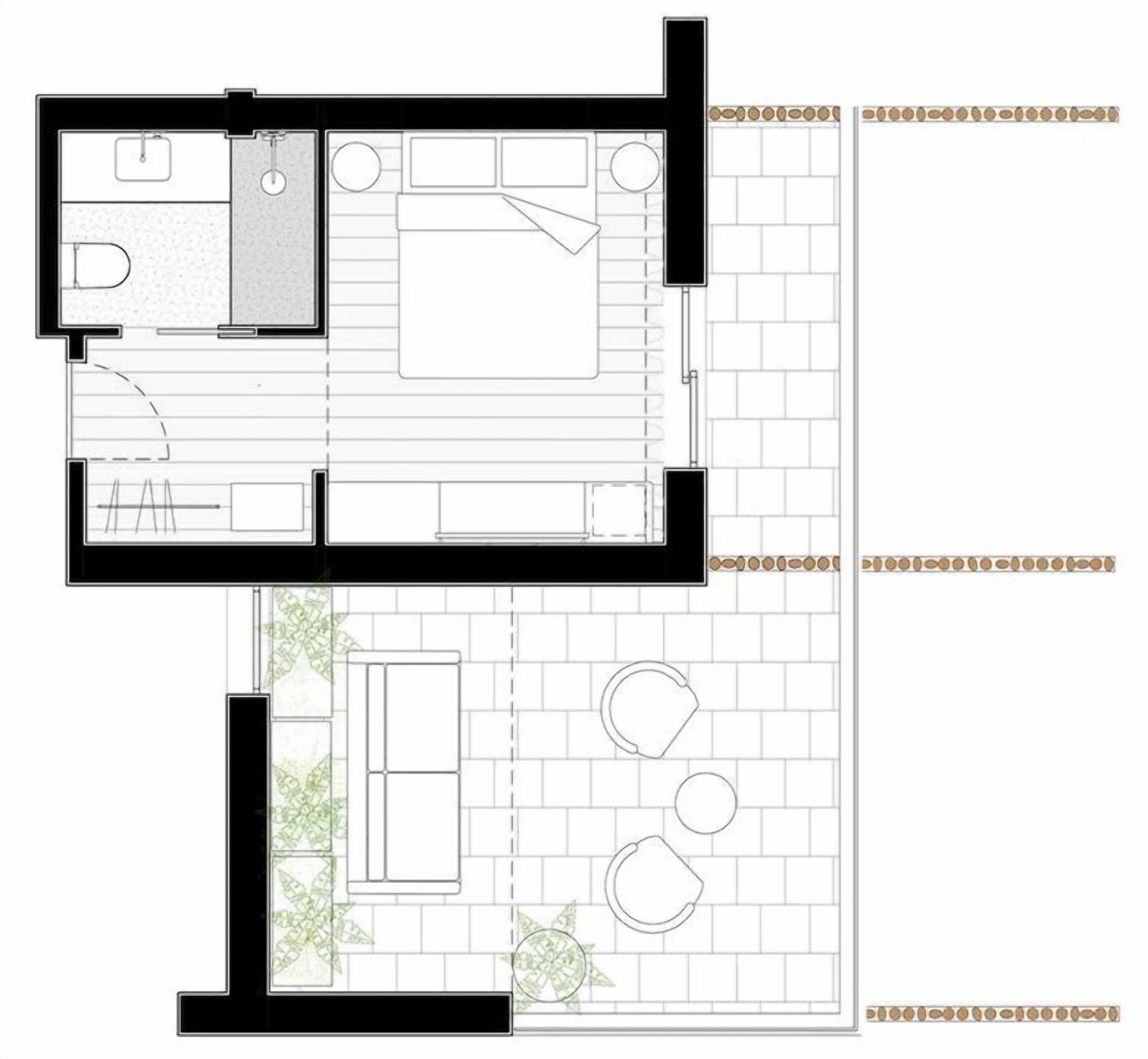 A floor plan of a hotel room with a bathroom, a kitchenette, a seating area with a sofa and two chairs, and a small garden area with plants.