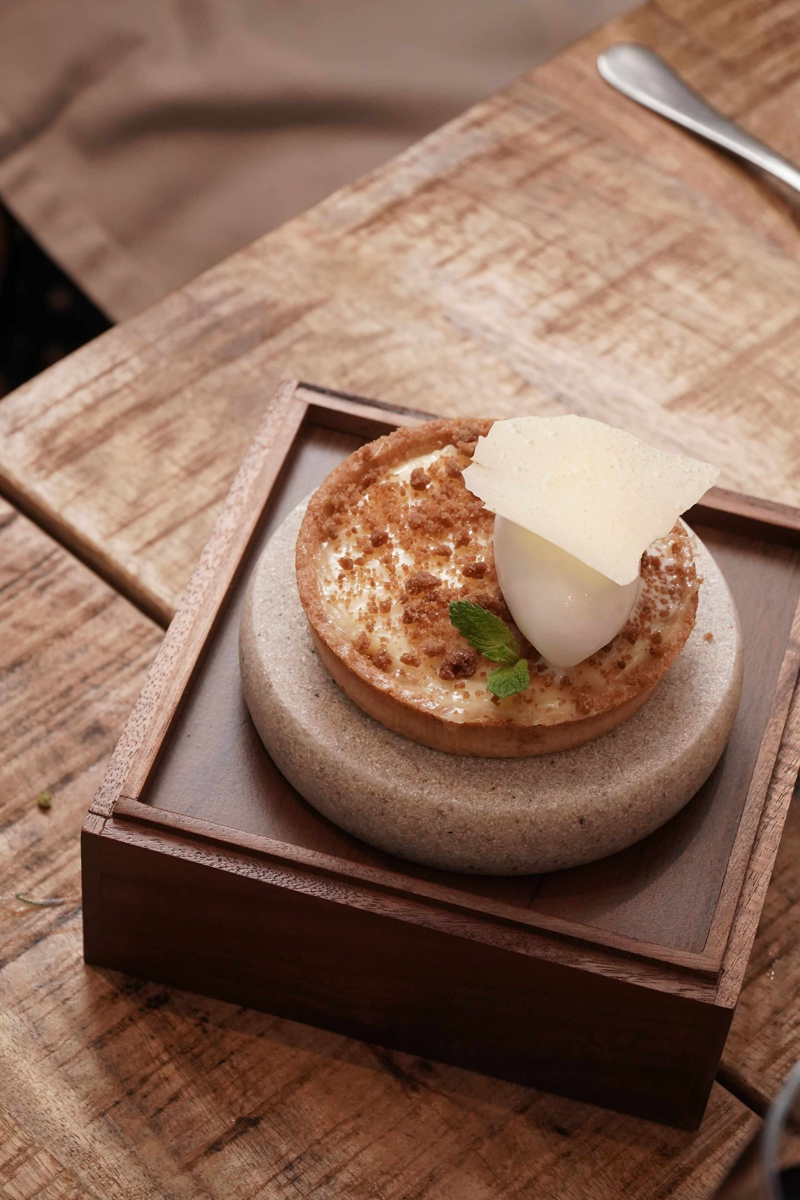 A dessert on a wooden tray.