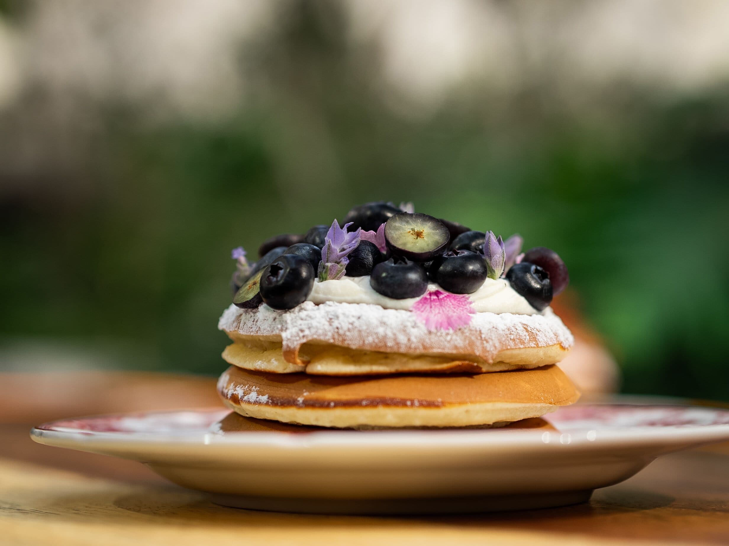 A dessert with layers and fruit on a plate.