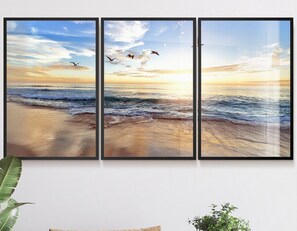 A three-panel panoramic wall art of a beach scene with waves and birds.